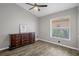 Cozy bedroom with a vintage dresser, ceiling fan, and window offering a comfortable retreat at 1862 Wood Bend St, Tarpon Springs, FL 34689