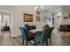 Elegant dining area featuring a modern glass table with seating, contemporary lighting, and seamless flow into the living space at 1862 Wood Bend St, Tarpon Springs, FL 34689