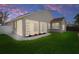 Home's backyard has a screened-in porch, landscaped with rock and mulch, that leads to the grassy lawn at 1862 Wood Bend St, Tarpon Springs, FL 34689