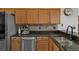 Granite countertops, stainless appliances, and wood cabinets highlight this kitchen at 1862 Wood Bend St, Tarpon Springs, FL 34689