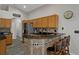 Kitchen with breakfast bar, tiled backsplash, and ample cabinet space at 1862 Wood Bend St, Tarpon Springs, FL 34689