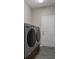 Modern laundry room with gray washer and dryer set, offering convenience and efficiency for household chores at 1862 Wood Bend St, Tarpon Springs, FL 34689