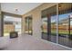 Covered patio has tile flooring, access to the yard through sliding glass doors, and a decorative fire pit at 1862 Wood Bend St, Tarpon Springs, FL 34689