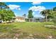 Expansive backyard featuring lush greenery and a screened-in pool area, ideal for outdoor enjoyment at 2172 Whitewood Ave, Spring Hill, FL 34609