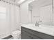 Clean bathroom with a combination shower and tub, a large mirror, and plenty of counter space at 2172 Whitewood Ave, Spring Hill, FL 34609