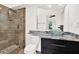 Modern bathroom featuring a glass shower with stone accents and a vessel sink on a granite countertop at 2172 Whitewood Ave, Spring Hill, FL 34609