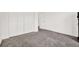 Spacious bedroom with plush carpeting and ample closet space, perfect for storage and organization at 2172 Whitewood Ave, Spring Hill, FL 34609
