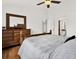 Bedroom featuring wood floors, ceiling fan, and view to en-suite bathroom and living room at 2172 Whitewood Ave, Spring Hill, FL 34609