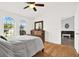Cozy main bedroom with hardwood floors, bright light from arched windows, and neutral paint at 2172 Whitewood Ave, Spring Hill, FL 34609