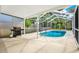Enclosed pool area featuring a sparkling blue pool, perfect for relaxing and entertaining in privacy at 2172 Whitewood Ave, Spring Hill, FL 34609