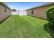 Wide shot of the green backyard area showing the privacy fence at 22316 Red Jacket Ln, Land O Lakes, FL 34639