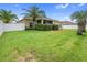 Expansive backyard features lush green grass, well-maintained landscaping, and a white privacy fence at 22316 Red Jacket Ln, Land O Lakes, FL 34639