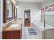 Bright bathroom featuring double vanity, soaking tub, shower, and window with privacy shade at 22316 Red Jacket Ln, Land O Lakes, FL 34639