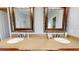 Bathroom featuring a double vanity with quartz countertop and vintage framed mirrors at 22316 Red Jacket Ln, Land O Lakes, FL 34639