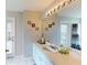 Bathroom with white cabinets, decorative mirror, exterior access, and a shower with patterned curtain at 22316 Red Jacket Ln, Land O Lakes, FL 34639