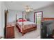 This bedroom features a ceiling fan, a four-poster bed, and multiple wooden dressers at 22316 Red Jacket Ln, Land O Lakes, FL 34639
