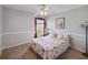 This bedroom features carpet, a ceiling fan, and a small window to the outside at 22316 Red Jacket Ln, Land O Lakes, FL 34639