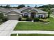 Charming single-story home with manicured lawn, mature landscaping, and a two-car garage at 22316 Red Jacket Ln, Land O Lakes, FL 34639