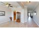 Spacious hallway with hardwood floors, arched doorway, and an open view into the living spaces at 22316 Red Jacket Ln, Land O Lakes, FL 34639