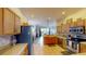 Open kitchen featuring wooden cabinets, stainless steel appliances, and seamless flow to living area at 22316 Red Jacket Ln, Land O Lakes, FL 34639