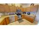 Well-lit kitchen with wooden cabinets, stainless steel appliances, and tile flooring at 22316 Red Jacket Ln, Land O Lakes, FL 34639