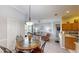 Open-concept living room featuring a cozy dining area, comfortable seating, and sliding glass doors at 22316 Red Jacket Ln, Land O Lakes, FL 34639
