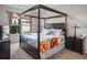 This main bedroom features a dark wood, four-poster bed with an upholstered headboard and floral bedding at 22316 Red Jacket Ln, Land O Lakes, FL 34639