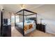 Bedroom with dark wood four-poster bed with upholstered headboard, dressers, ceiling fan, and carpeted floors at 22316 Red Jacket Ln, Land O Lakes, FL 34639