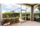 The outdoor patio offers screened-in space with views of palm trees and well manicured landscaping at 22316 Red Jacket Ln, Land O Lakes, FL 34639