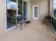 Screened patio features chairs and a sliding glass door that opens to the living room at 22316 Red Jacket Ln, Land O Lakes, FL 34639