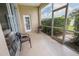 Screened patio features chairs, offering an outdoor space with views of lush greenery at 22316 Red Jacket Ln, Land O Lakes, FL 34639