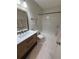 Well-lit bathroom featuring a modern vanity and a shower-tub combination at 2270 Alden Ln # A, Palm Harbor, FL 34683