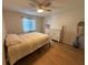 Bright bedroom with wood floors, a ceiling fan, and a large dresser at 2270 Alden Ln # A, Palm Harbor, FL 34683