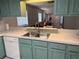 Kitchen featuring modern appliances, including a dishwasher and stainless steel sink at 2270 Alden Ln # A, Palm Harbor, FL 34683