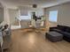 Open concept living space with modern furniture, wood floors, and access to the kitchen at 2270 Alden Ln # A, Palm Harbor, FL 34683