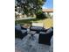 Outdoor patio with cushioned seating, a small table, and a view of the well-manicured lawn at 2270 Alden Ln # A, Palm Harbor, FL 34683