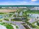 Aerial view of the community entrance with palm trees and well-maintained landscaping at 2572 Garden Plum Pl, Odessa, FL 33556
