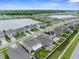 Aerial view of a Gathering friendly community with a lake, sidewalks, and green spaces at 2572 Garden Plum Pl, Odessa, FL 33556