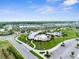 An aerial shot capturing the community pool, clubhouse, and surrounding neighborhood with lush landscaping at 2572 Garden Plum Pl, Odessa, FL 33556