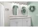 Stylish bathroom featuring double vanity sinks, decorative wall mirrors and contemporary lighting at 2572 Garden Plum Pl, Odessa, FL 33556