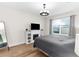 A modern bedroom with a window for natural lighting and a simple decorative fireplace at 2572 Garden Plum Pl, Odessa, FL 33556