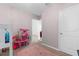 bedroom showing a play area, carpet, and access to the hallway at 2572 Garden Plum Pl, Odessa, FL 33556