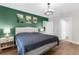 Bedroom with green walls, and a comfortable looking bed at 2572 Garden Plum Pl, Odessa, FL 33556