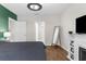 Bright bedroom featuring wood floors, a fireplace, and an en-suite bathroom at 2572 Garden Plum Pl, Odessa, FL 33556