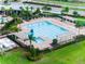 Aerial view of the community pool area with ample lounge chairs and shaded seating at 2572 Garden Plum Pl, Odessa, FL 33556
