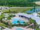 Aerial view of the community pool featuring a large swimming area, chairs, and sunbathing spaces at 2572 Garden Plum Pl, Odessa, FL 33556