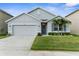 Beautiful single-Gathering home with a two-car garage, landscaping, and a well-kept lawn at 2572 Garden Plum Pl, Odessa, FL 33556