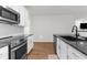 This kitchen has stainless steel appliances, white cabinets, and granite countertops at 2572 Garden Plum Pl, Odessa, FL 33556
