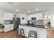 Bright kitchen features stainless steel appliances, modern countertops and fixtures, and an island with seating at 2572 Garden Plum Pl, Odessa, FL 33556