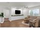 Bright living room with an accent wall, built-in cabinets, and large windows at 2572 Garden Plum Pl, Odessa, FL 33556
